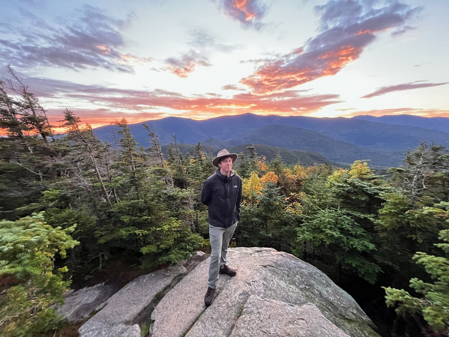 Standing above the world at sunset’s edge