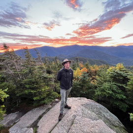 Standing above the world at sunset’s edge